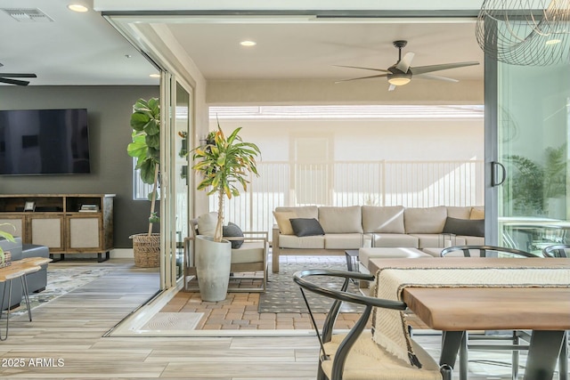 sunroom featuring ceiling fan