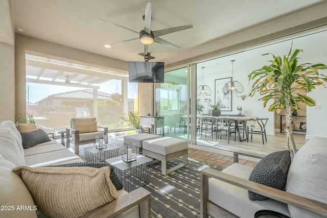 sunroom featuring ceiling fan