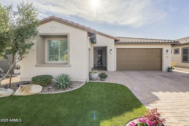 mediterranean / spanish home with a front lawn and a garage