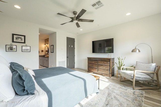 bedroom featuring ensuite bathroom, ceiling fan, and light hardwood / wood-style floors