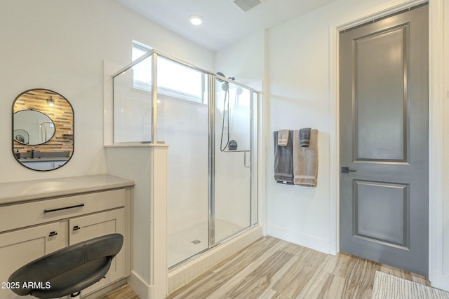 bathroom with vanity and a shower with shower door