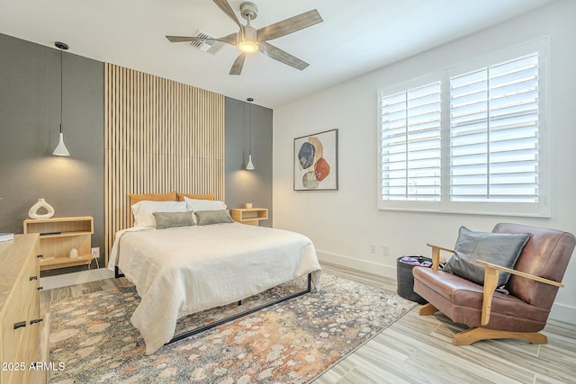 bedroom with ceiling fan and light wood-type flooring