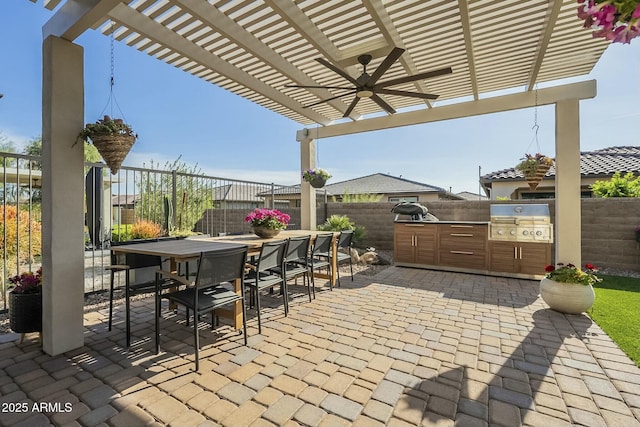 view of patio / terrace featuring a pergola, an outdoor kitchen, ceiling fan, and a grill