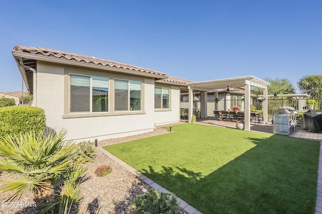 back of house with a pergola, a yard, and a patio