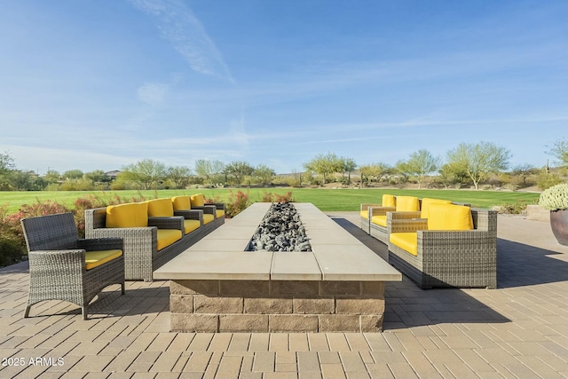 view of patio featuring an outdoor living space with a fire pit