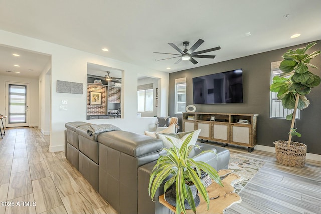 living room featuring plenty of natural light and ceiling fan