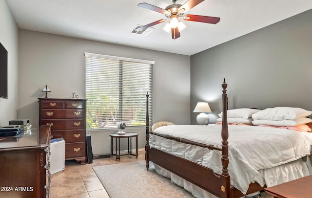 tiled bedroom featuring ceiling fan