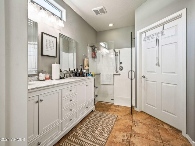 bathroom featuring an enclosed shower and vanity