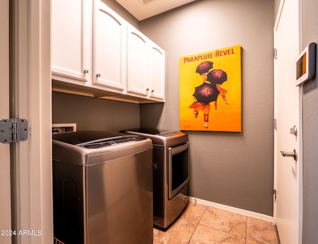 laundry area with cabinets, independent washer and dryer, and light tile patterned floors