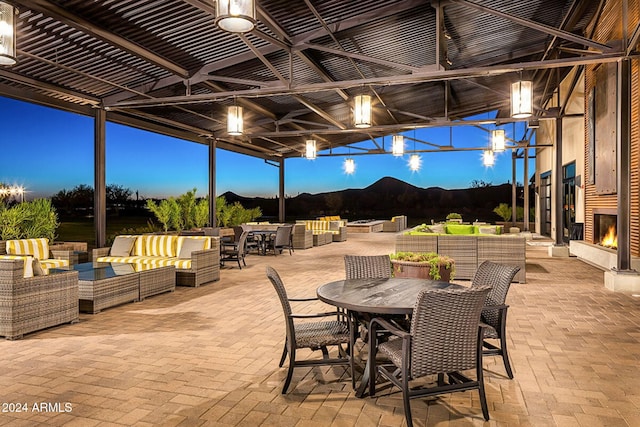 patio terrace at dusk with a mountain view and an outdoor living space