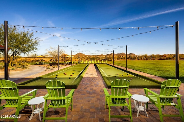 view of property's community featuring a lawn and a mountain view