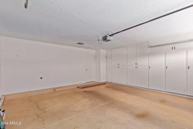 garage with a garage door opener and visible vents