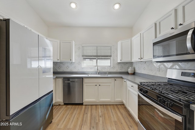 kitchen with sink, stainless steel appliances, and white cabinets