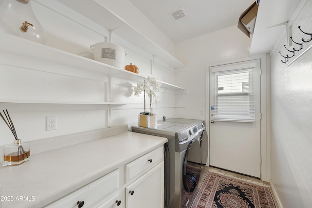 laundry room featuring cabinets and independent washer and dryer