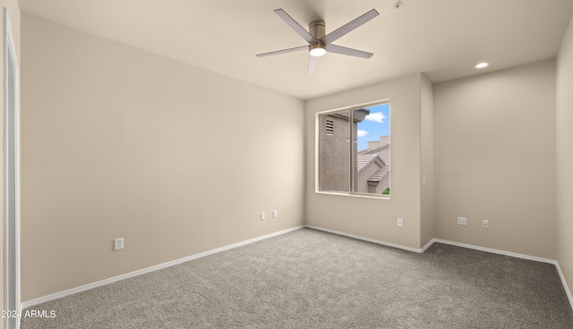 carpeted empty room featuring ceiling fan