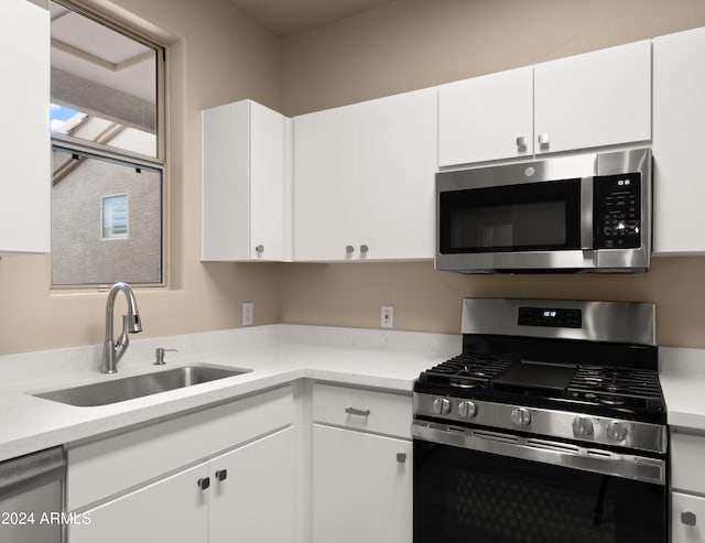 kitchen with white cabinets, sink, and stainless steel appliances