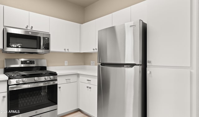 kitchen featuring appliances with stainless steel finishes and white cabinetry