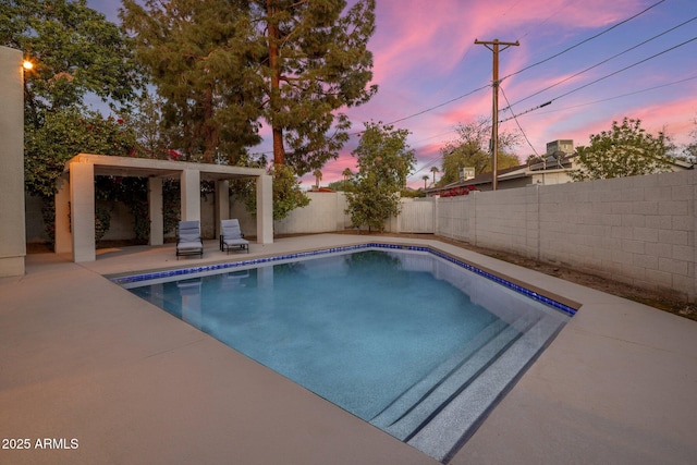 1209 W Golden Ln, Phoenix, AZ 85021 - pool at dusk with a fenced backyard, a fenced in pool, and a patio