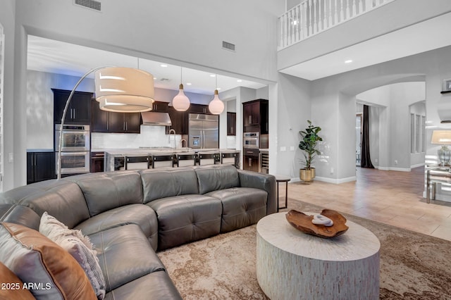 tiled living room with a high ceiling