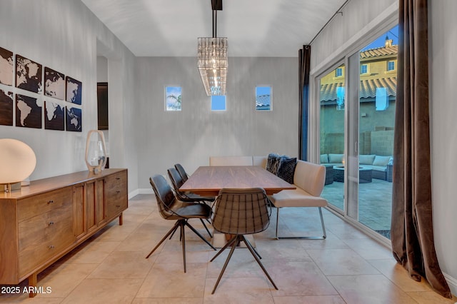 dining area featuring a notable chandelier