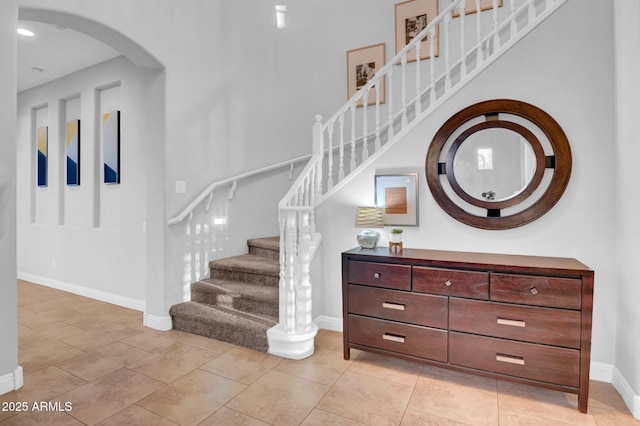 staircase with tile patterned floors