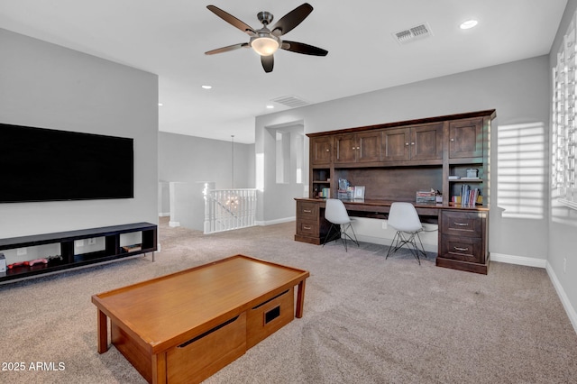 carpeted home office with ceiling fan and a wealth of natural light