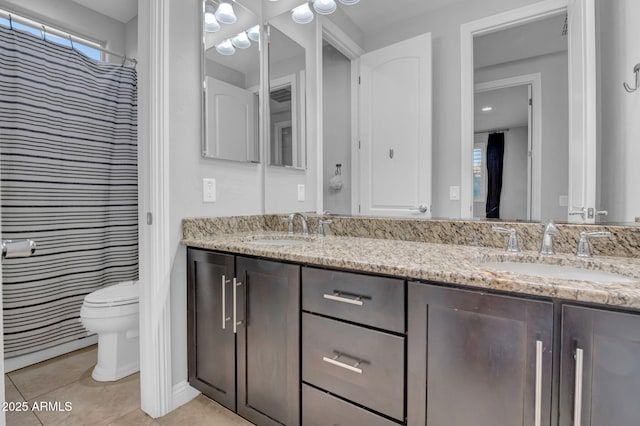 bathroom featuring toilet, tile patterned floors, and vanity