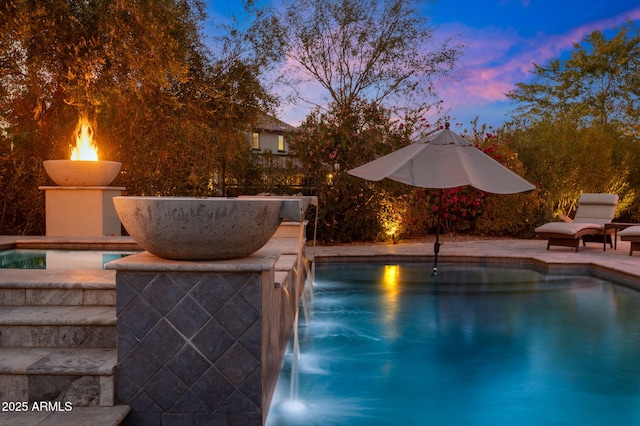 view of pool at dusk