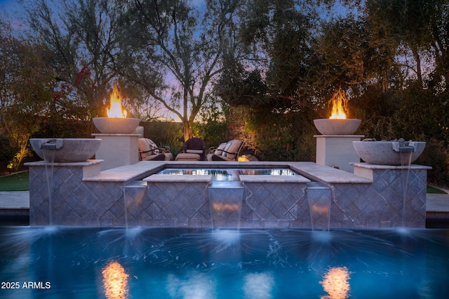 view of pool at dusk