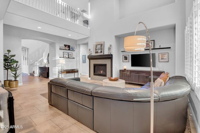 tiled living room featuring a high ceiling