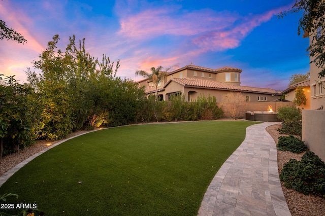 view of yard at dusk