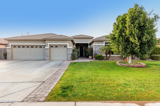 view of front of house with a garage and a front lawn