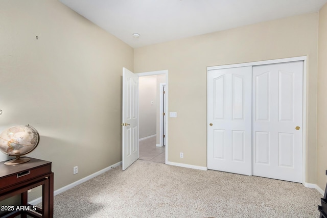 unfurnished bedroom featuring light colored carpet and a closet