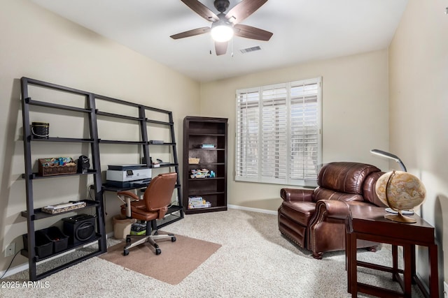 carpeted home office with ceiling fan