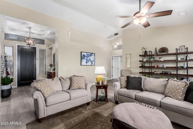 living room featuring ceiling fan, dark hardwood / wood-style flooring, and vaulted ceiling