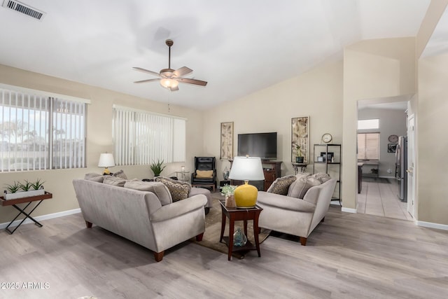 living room featuring vaulted ceiling, ceiling fan, and light hardwood / wood-style floors