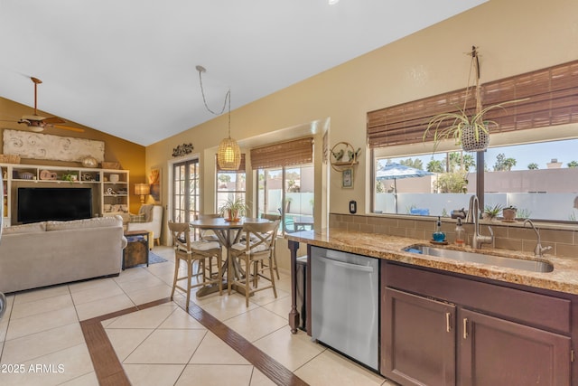 kitchen with dishwasher, a sink, a wealth of natural light, and hanging light fixtures