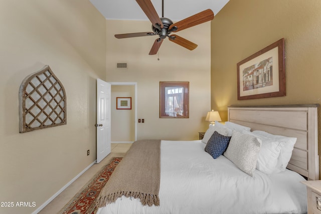 bedroom with a high ceiling, ceiling fan, visible vents, carpet, and baseboards