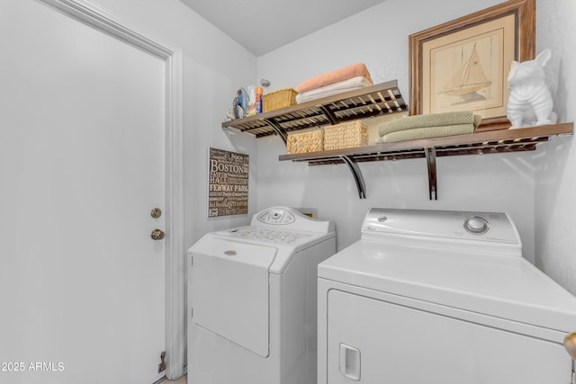 laundry area with washing machine and clothes dryer and laundry area