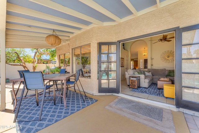view of patio featuring outdoor dining area and fence