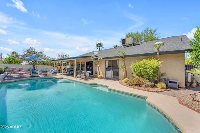 view of pool with fence, a patio area, central AC, and a fenced in pool
