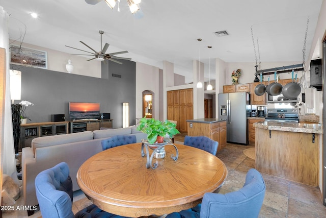 dining space with visible vents, high vaulted ceiling, and ceiling fan