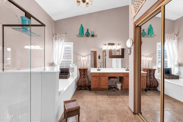 full bath featuring a shower stall, a tub, double vanity, an inviting chandelier, and a sink