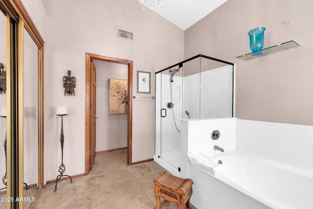 full bath with visible vents, a stall shower, baseboards, and a garden tub