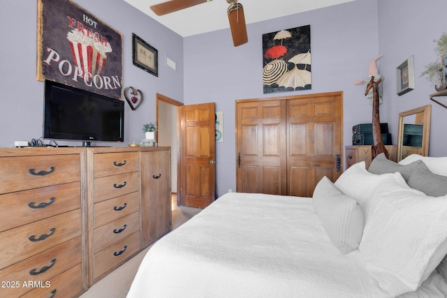 bedroom featuring a ceiling fan, a closet, and a towering ceiling