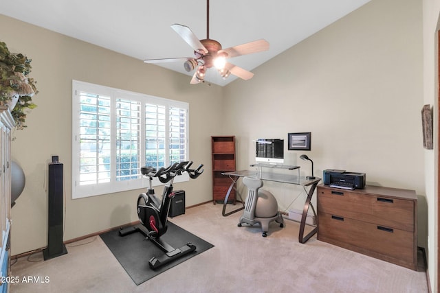 exercise room featuring light carpet, baseboards, a ceiling fan, and vaulted ceiling