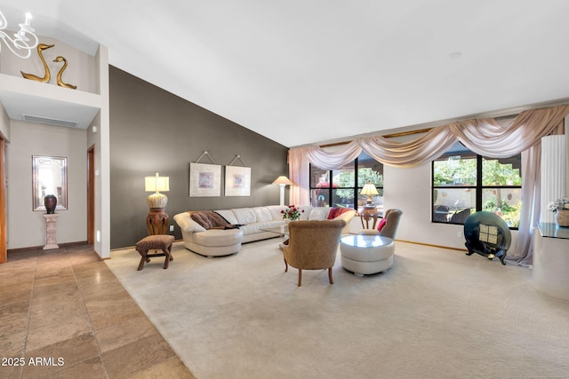 carpeted living room with baseboards and high vaulted ceiling