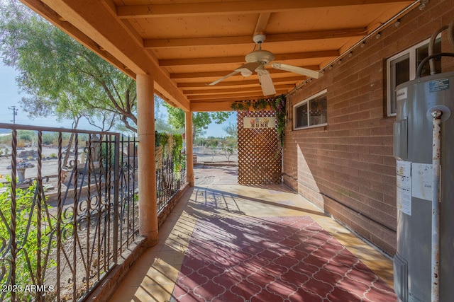 wooden deck featuring ceiling fan, a patio, and water heater