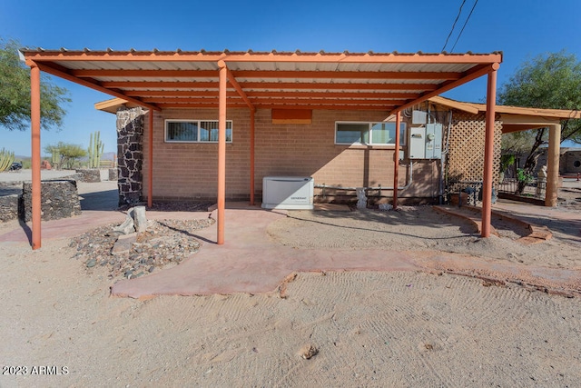 back of house with a carport