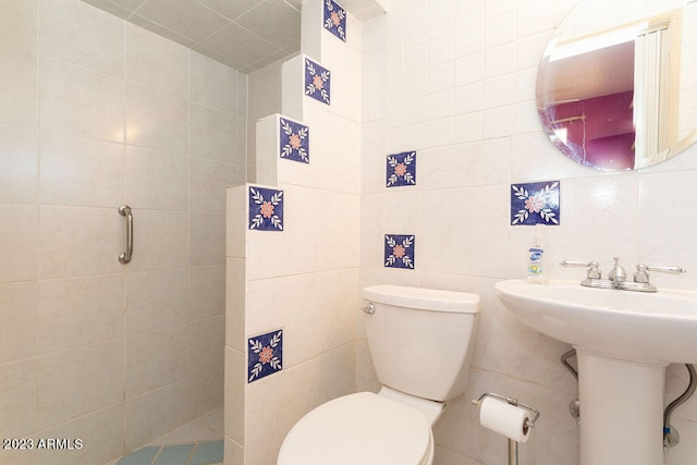 bathroom with tile walls and toilet